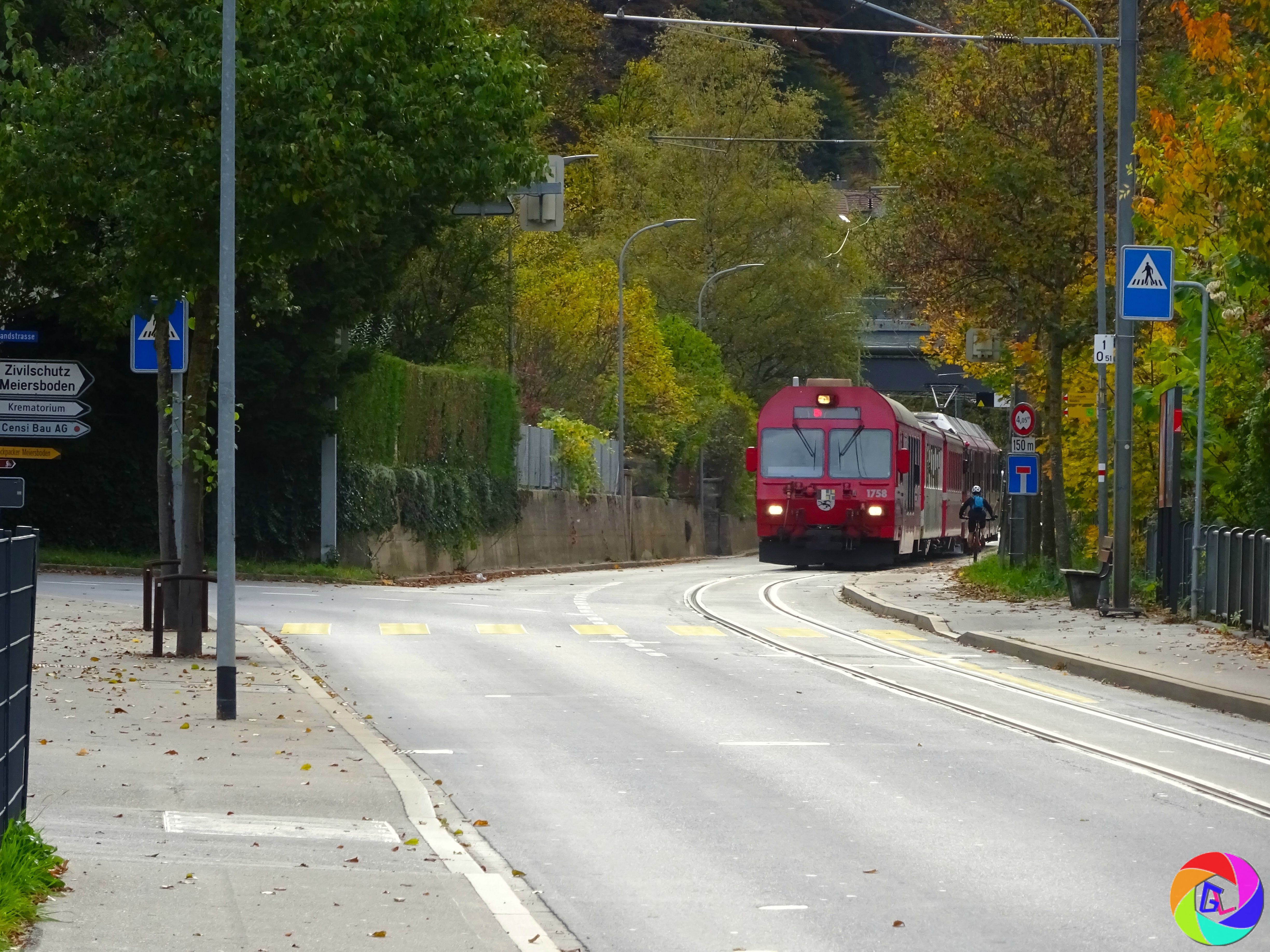 Arosa Line trains travel through streets as they leave the city